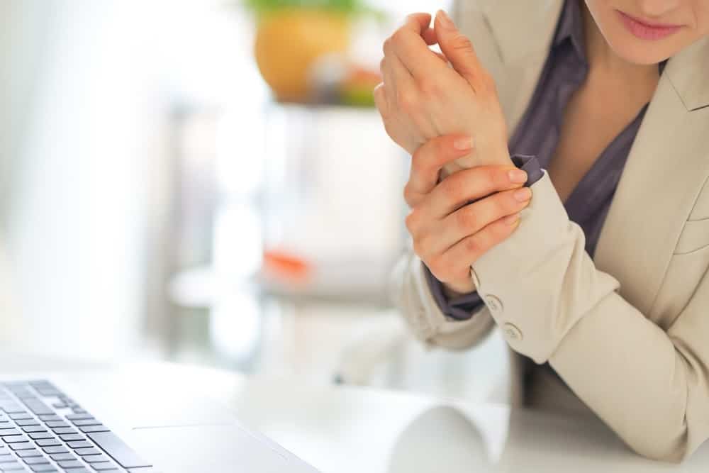 Woman massaging her wrist