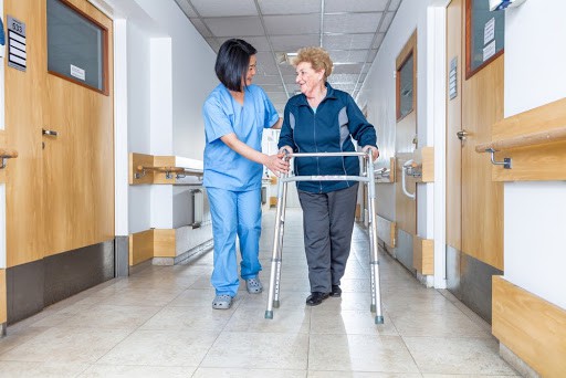 Nurse Helping Someone in Hallway