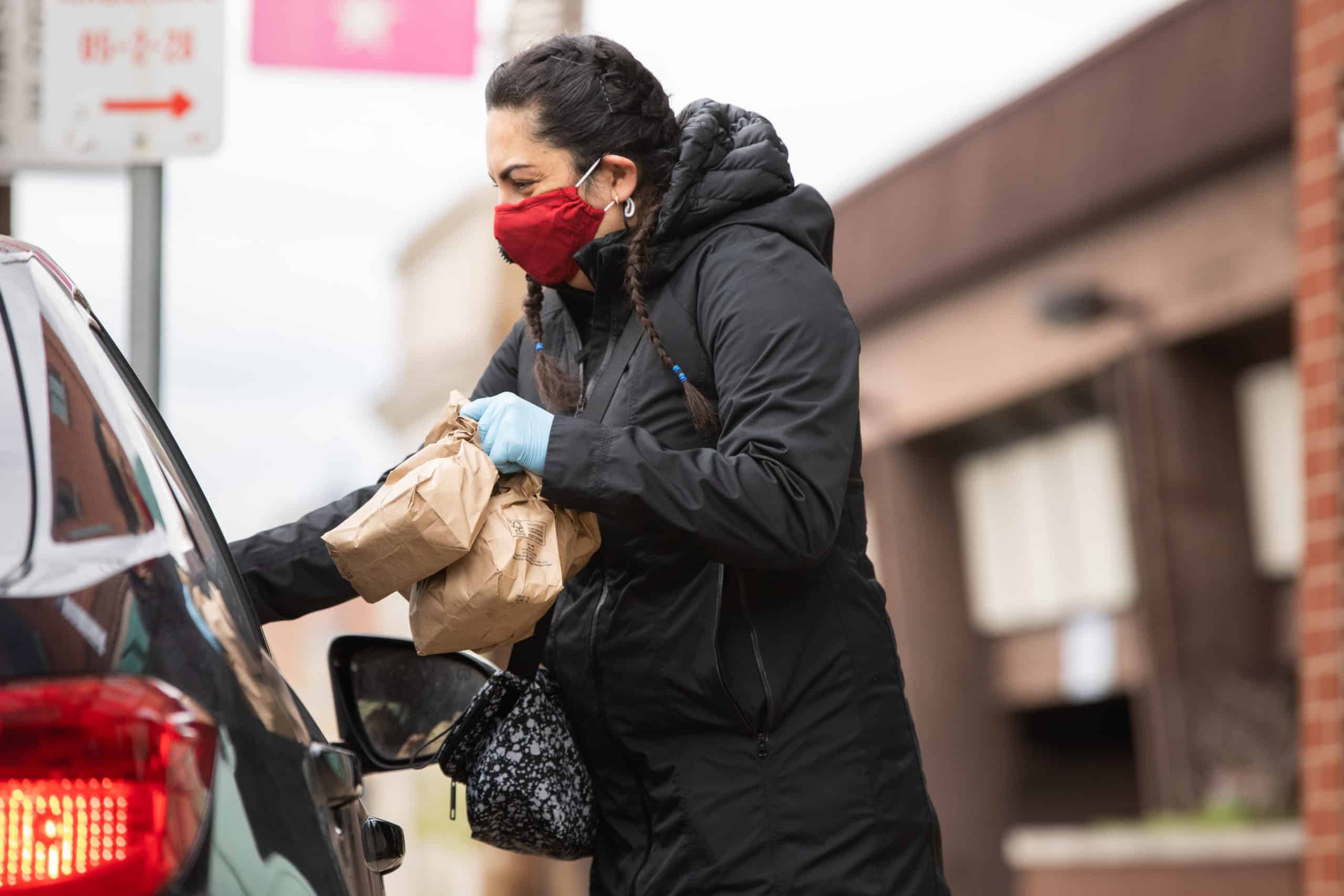 A United Way Volunteer Handing Food Into a Car