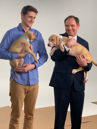 Mitch Dugan holding dog during Animal Friends commercial shoot.