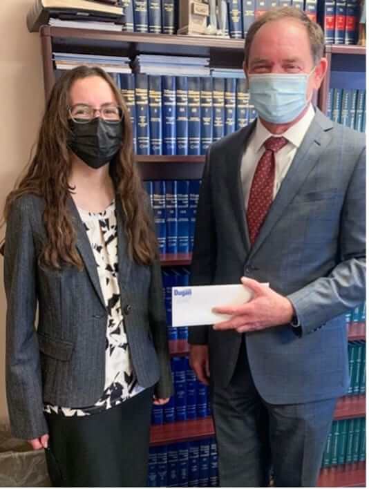 Mitch Dugan awarding a check to the firm's 2021 college scholarship recipient Laura Bowden.