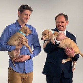 Mitch Dugan holding a dog at an Animal Friends commercial taping.