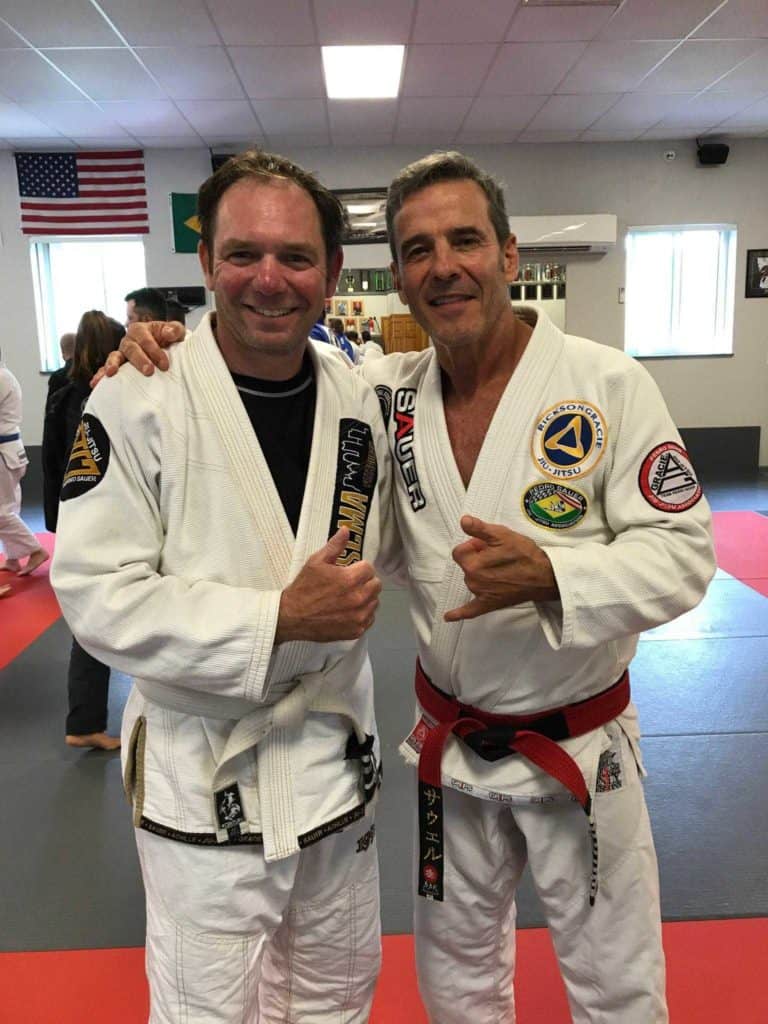 Mitch Dugan standing with his Brazilian jiu-jitsu instructor.