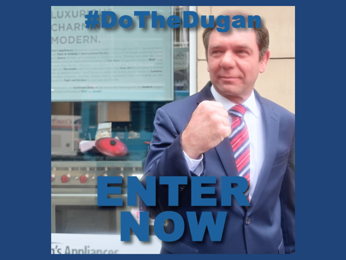 Mitch standing on the corner of Fifth Avenue in downtown Pittsburgh making the D-U-G-A-N Fist with text that reads, "#DoTheDugan, ENTER NOW."